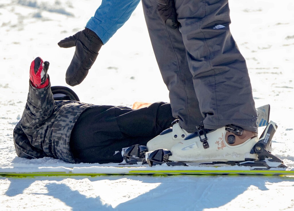 (Francisco Kjolseth | The Salt Lake Tribune) A young skier gets a helping hand off the snow as people enjoy clear skies and some recent fresh snow at Park City Mountain Resort on Saturday, Dec. 18, 2021.
