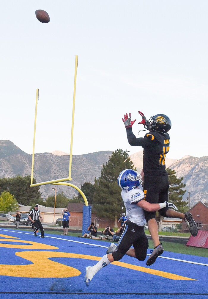 (Francisco Kjolseth  |  The Salt Lake Tribune)  Orem's Puka Nacua pulls in a touchdown pass over Braedon Wissler of Bingham in the first half of the game in Orem, Thursday, Aug. 16, 2018.