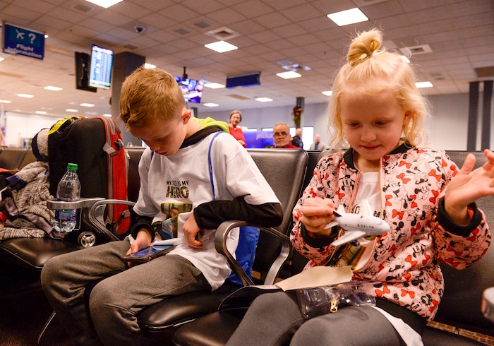 (Leah Hogsten | The Salt Lake Tribune) l-r Jacob Taylor, 8, and his sister Ellie, 6, play at the gate on Saturday. Ten Gold Star families from Salt Lake City were treated to a Winter Wonderland scene, including Whoville and the Grinch at their boarding gate at Salt Lake International Airport, Dec. 7, 2019 before their flight to Disney World aboard the Snowball Express. This month, the Gary Sinise Foundation's Snowball Express will fly more than 1,700 family members of fallen U.S. military heroes to Disney World for a holiday retreat.