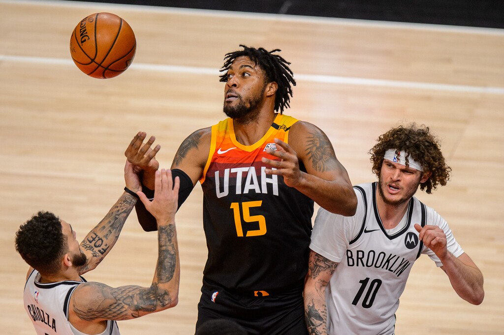 (Trent Nelson | The Salt Lake Tribune) Utah Jazz center Derrick Favors (15) looks for the rebound as the Utah Jazz host the Brooklyn Nets, NBA basketball in Salt Lake City on Wednesday, March 24, 2021. At left is Brooklyn Nets guard Chris Chiozza (4) and right is Brooklyn Nets guard Tyler Johnson (10).