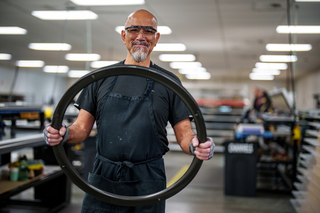 (Trent Nelson  |  The Salt Lake Tribune) Longtime ENVE employee Oscar Gorritti holds a carbon fiber rim at the company's Ogden facility on Tuesday, May 28, 2024.