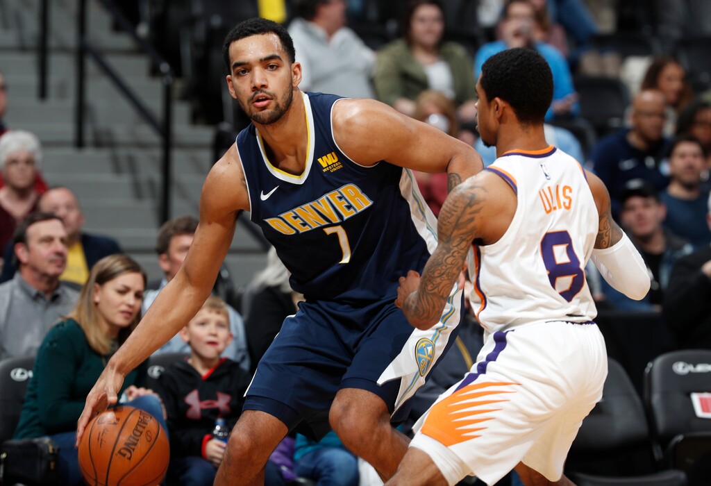 Denver Nuggets forward Trey Lyles, left, drives past Phoenix Suns guard Tyler Ulis during the first half of an NBA basketball game Friday, Jan. 19, 2018, in Denver. (AP Photo/David Zalubowski)