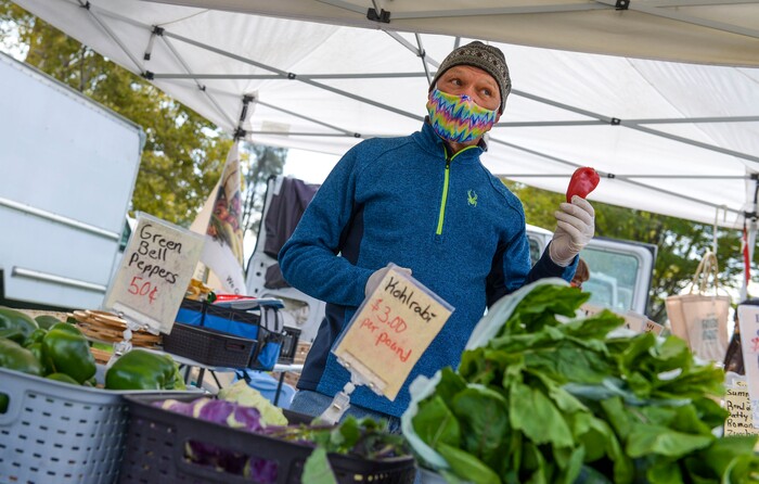 (Leah Hogsten  |  The Salt Lake Tribune) Randy Hed with Blue Spring Farm pitches his produce on the final day of the Salt Lake City Farmer's Market, Oct. 24, 2020. Hed and his wife Tamara are farmers from Bothwell who sell vegetables and greens every year at the market "There's been less people, but the people here are motivated to buy," said Tamara of the crowd on the last day.