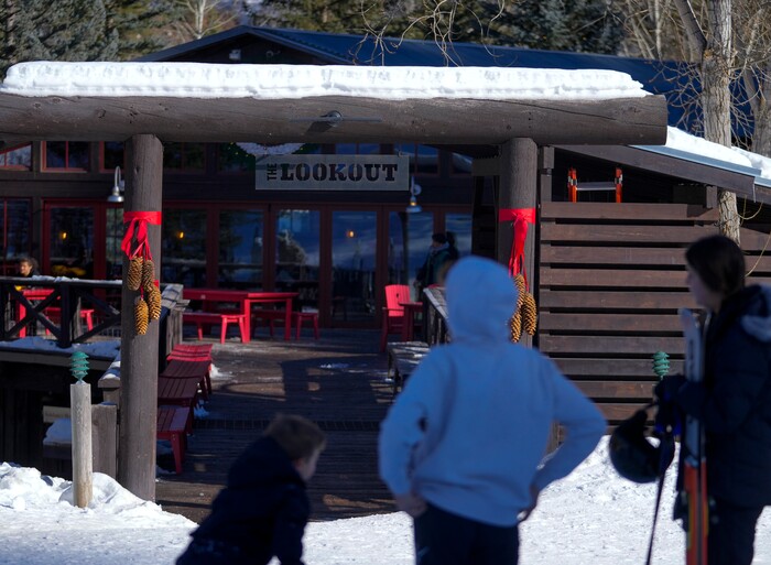 (Bethany Baker | The Salt Lake Tribune) People stand in front of a restaurant at Sundance Resort near Provo on Thursday, Dec. 14, 2023.