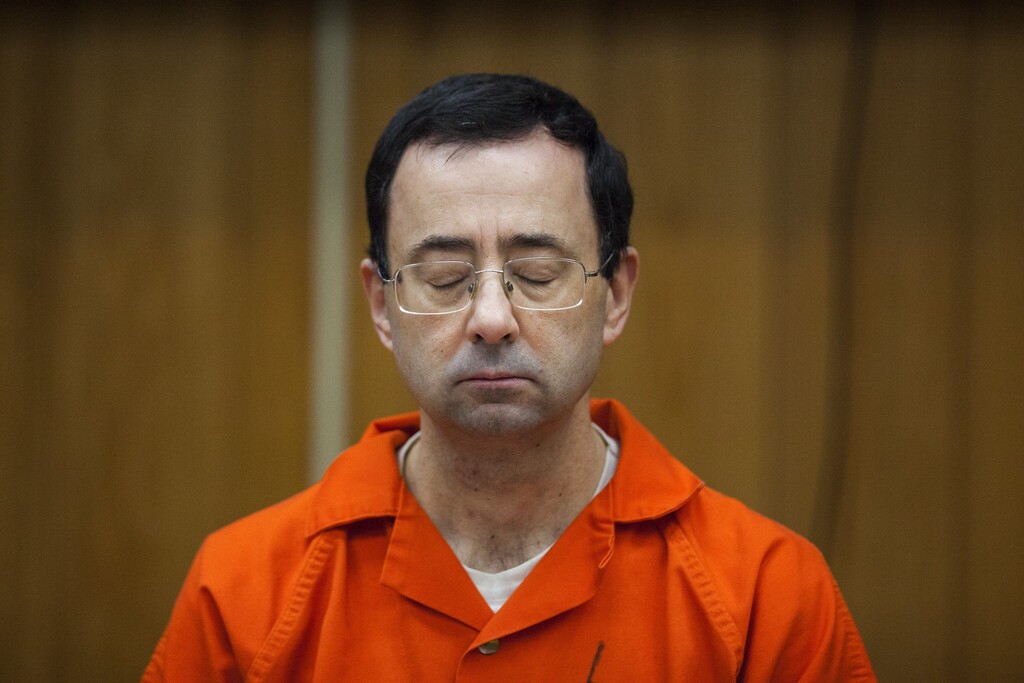 Larry Nassar listens during his sentencing at Eaton County Circuit Court in Charlotte, Mich.,  Monday, Feb. 5, 2018. The former Michigan State University sports-medicine and USA Gymnastics doctor received 40 to 125 years for three first degree criminal sexual abuse charges related to assaults that occurred at Twistars, a gymnastics facility in Dimondale. Nassar has also been sentenced to 60 years in prison for three child pornography charges in federal court and between 40 to 175 years in Ingham County for seven counts of criminal sexual conduct. (Cory Morse /The Grand Rapids Press via AP)