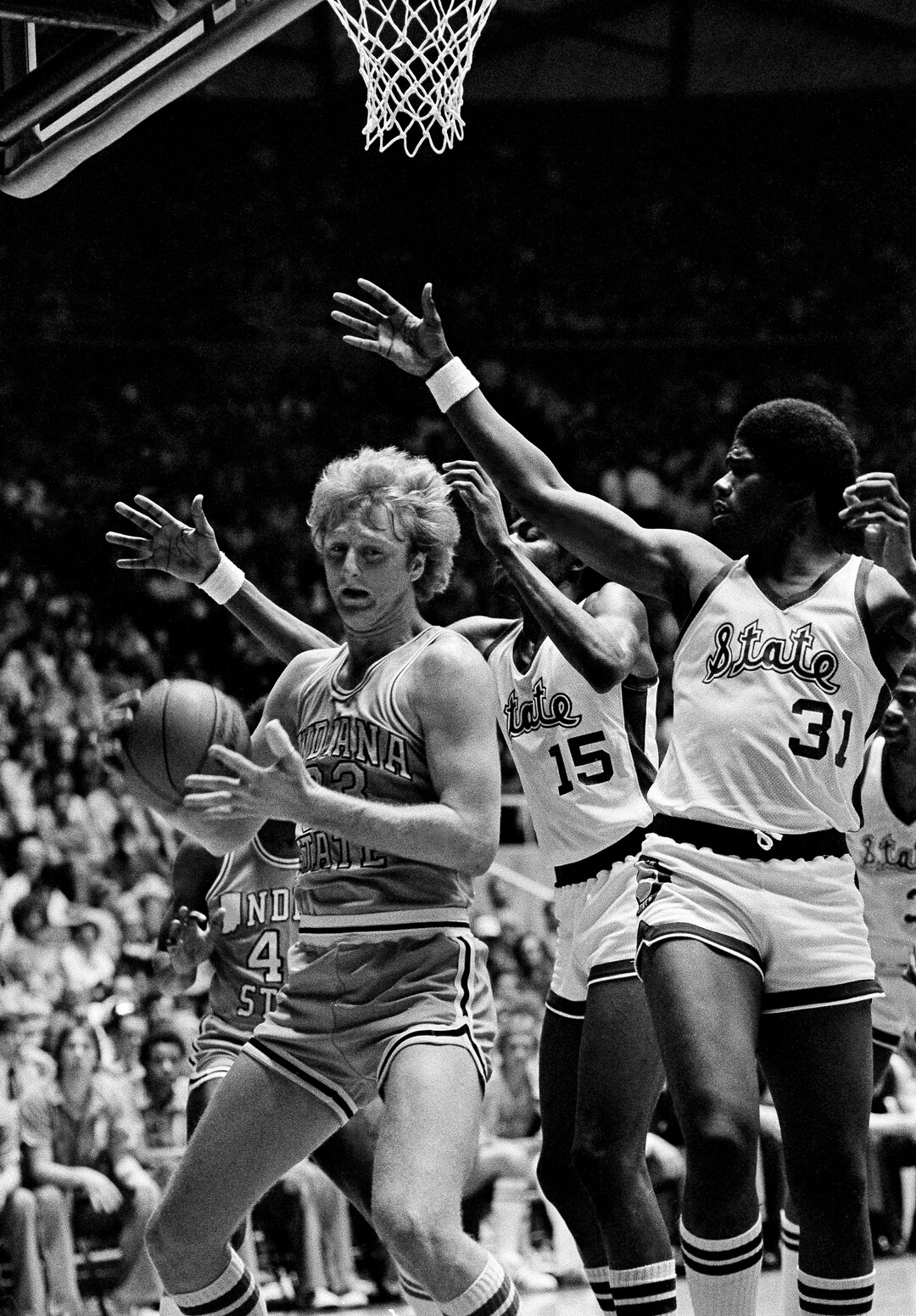 (AP Photo) Indiana State's Larry Bird (33) is surrounded by a sea of hands Monday, March 26, 1979 in Salt Lake City as he takes down a rebound during the finals of the NCAA basketball championships against Michigan State. 