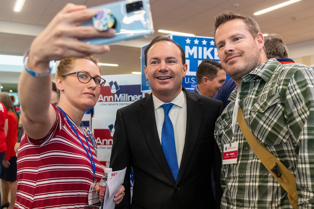 (Rick Egan | The Salt Lake Tribune) A couple of delegates grab a shot with US Sen. Mike Lee, at the Davis County Republican nominating convention at Farmington High School, on Saturday, March 26, 2022.