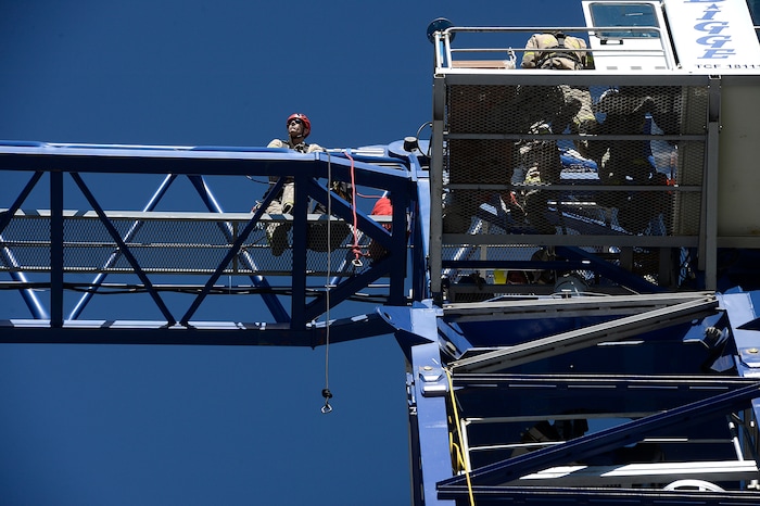 (Scott Sommerdorf | The Salt Lake Tribune) A firefighter takes in the view from 200 feet as the Park City Fire District conducts a high mountain rescue training exercise utilizing a Jacobsen tower crane and operator at the construction site of the One Empire Pass development at Deer Valley, Sunday, Aug. 20, 2017.