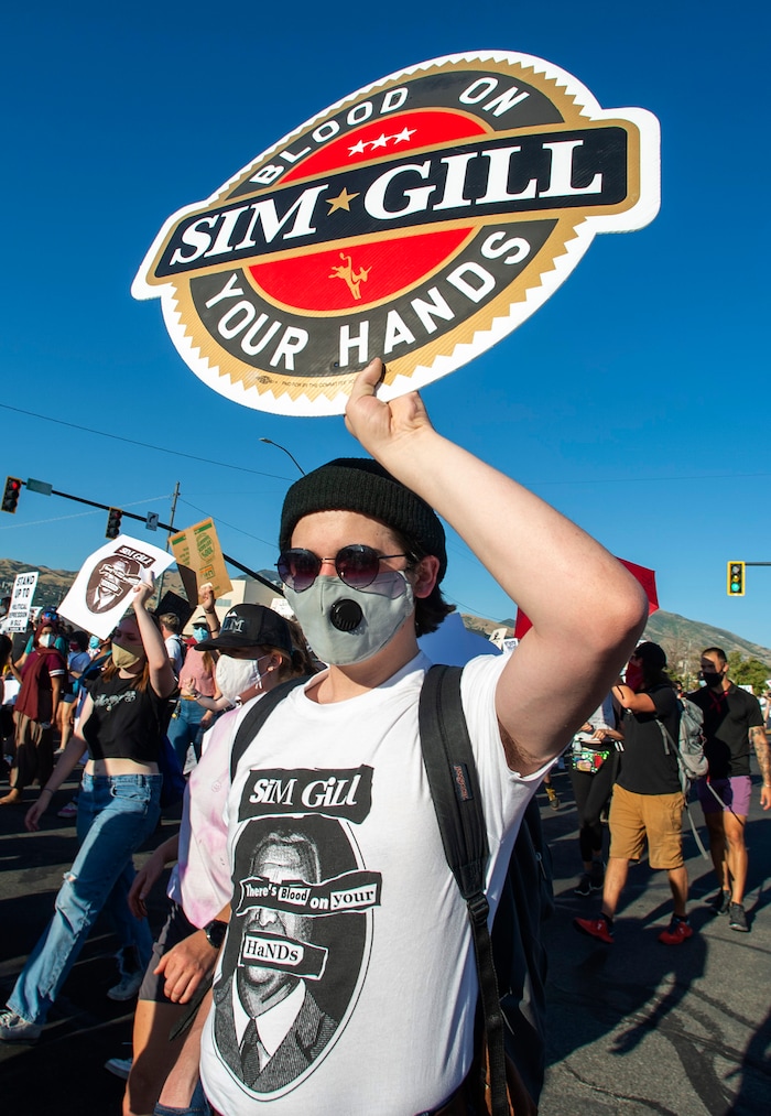 (Rick Egan  |  The Salt Lake Tribune)   Oscar Roche marches with protesters as they dance in the streets in downtown Salt Lake City, during the Dance Dance Revolution protest for racial equality, on Sunday, Aug. 9, 2020.