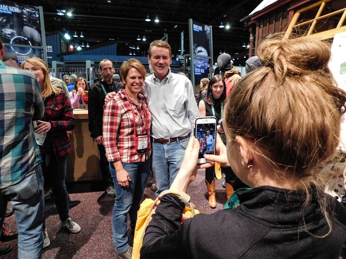 (Erin Alberty | The Salt Lake Tribune) U.S. Sen. Michael Bennet, D-Colorado, poses with a fan during a public lands discussion at the Outdoor Retailer show Jan. 27, 2018 at the Colorado Convention Center in Denver.
