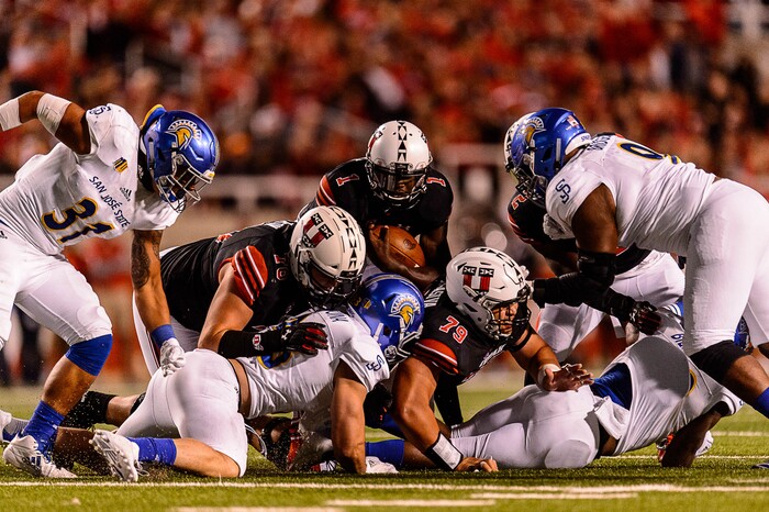 (Trent Nelson | The Salt Lake Tribune) Utah Utes quarterback Tyler Huntley (1) runs for a first down with a block from Utah Utes offensive lineman Jordan Agasiva (79) as the Utah Utes host the San Jose State Spartans, NCAA football at Rice-Eccles Stadium in Salt Lake City, Saturday September 16, 2017.