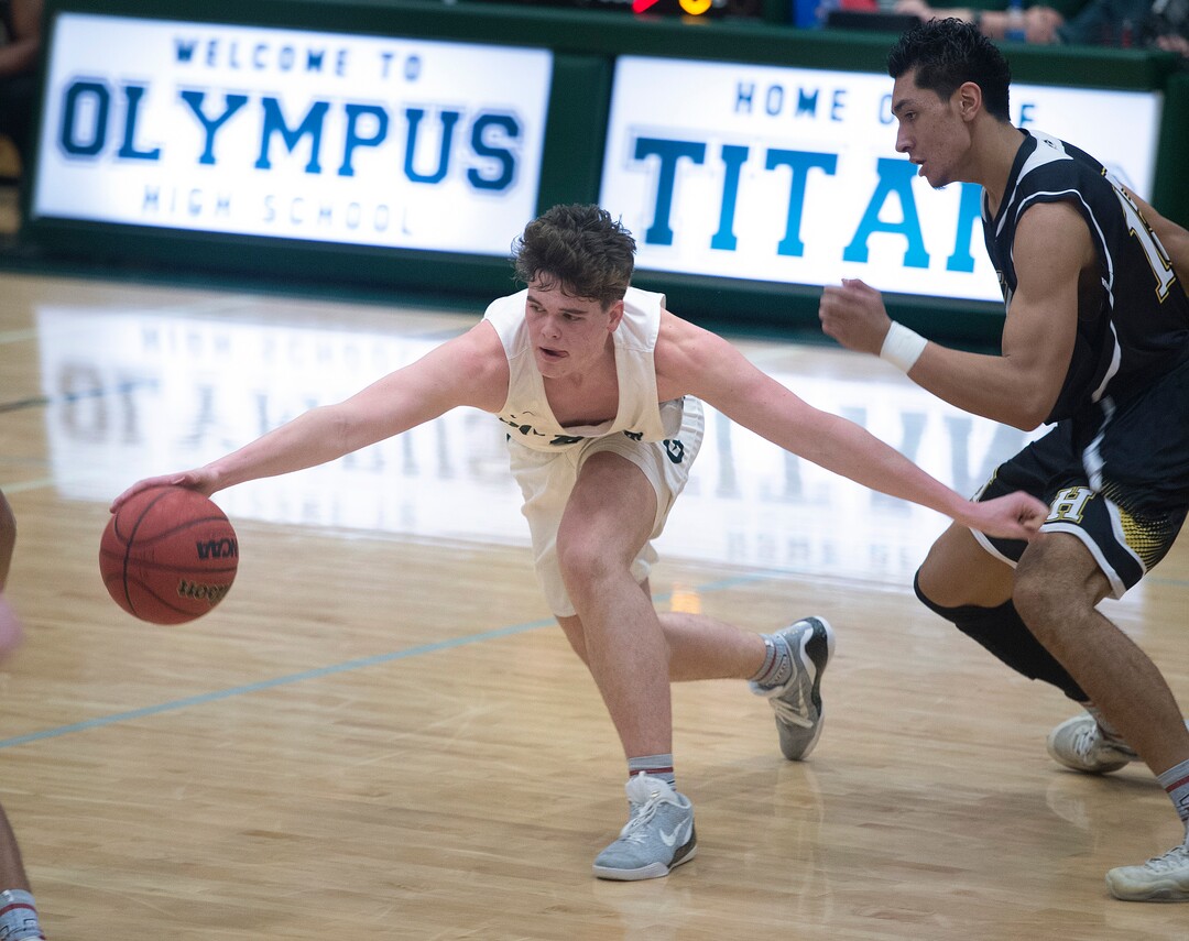 (Scott Sommerdorf   |  The Salt Lake Tribune)   Jeremy Dowdell struggles to regain control of a loose ball during second half play as Olympus defeated Highland 70-49, Friday, January 19, 2018.