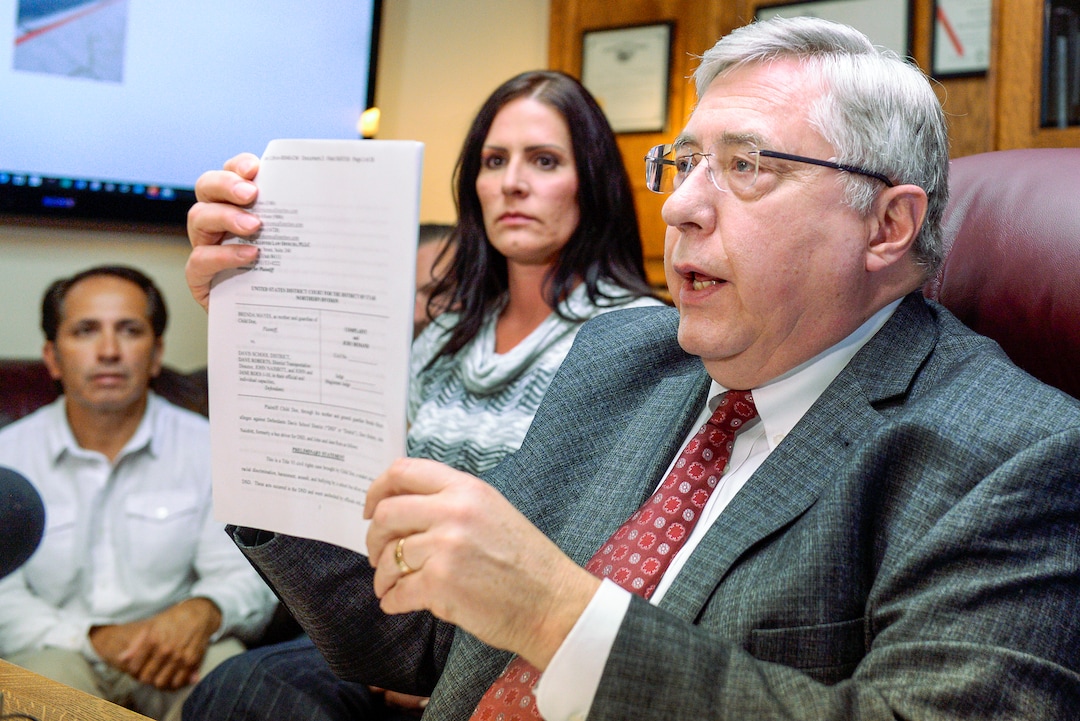 Leah Hogsten  |  The Salt Lake Tribune   Brenda Mayes, center, and her fiance Terry Martinez, left, joined attorney Robert Sykes, right, during a press conference announcing the lawsuit they filed, Tuesday, May 7, 2019 against the Davis School District, accusing a bus driver of racial discrimination against her son.