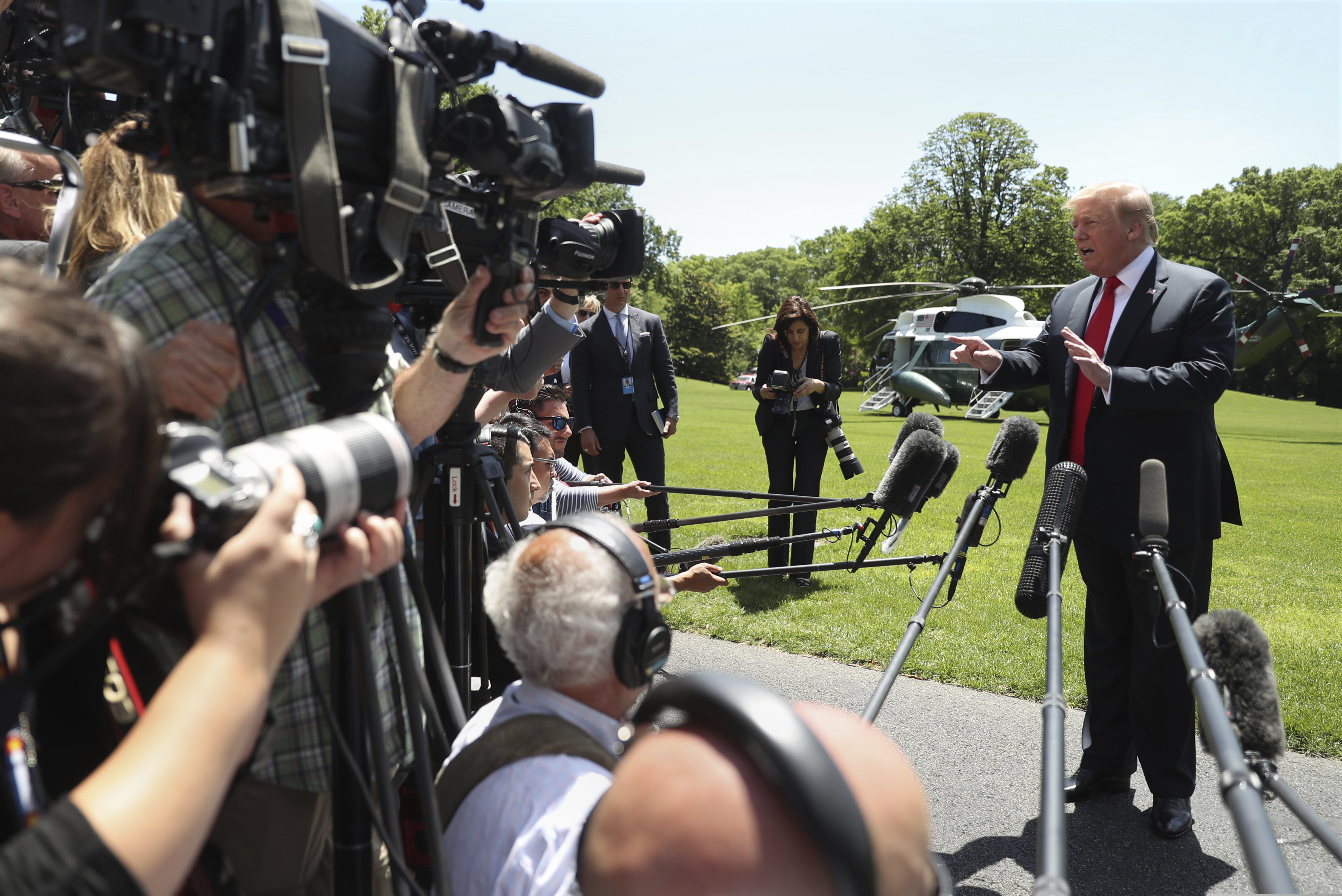 (Andrew Harnik | AP) President Donald Trump speaks to members of the media on the South Lawn of the White House in Washington, Friday, May 24, 2019, before boarding Marine One for a short trip to Andrews Air Force Base, Md., and then on to Tokyo.