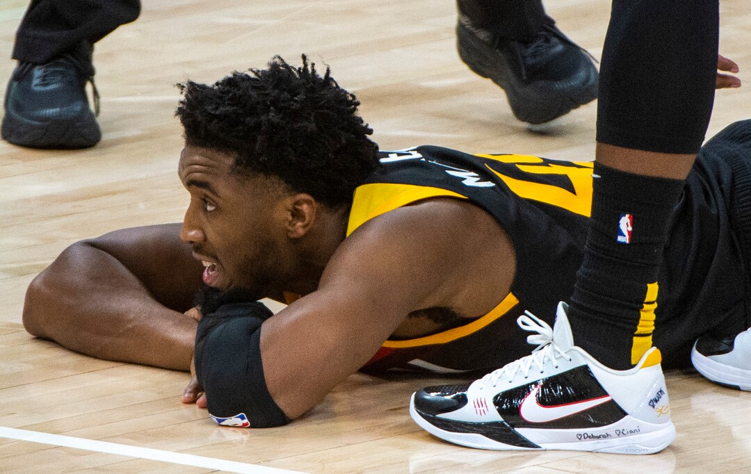 (Rick Egan | The Salt Lake Tribune) Utah Jazz guard Donovan Mitchell (45) lies the floor after being called for a personal foul, in NBA action between the Utah Jazz and the Philadelphia 76ers at Vivint Arena, on Monday, Feb. 15, 2021.