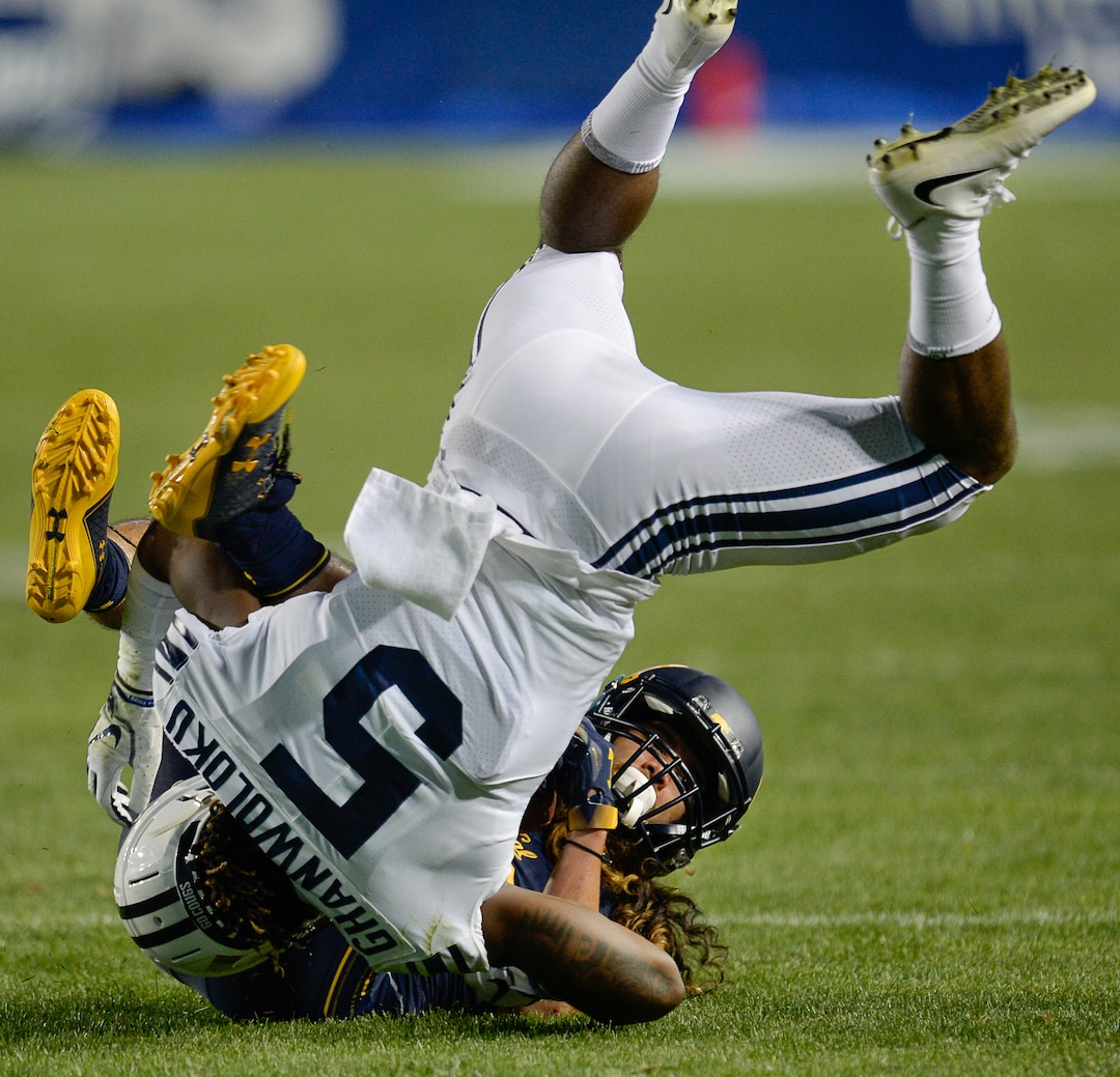 (Francisco Kjolseth  |  The Salt Lake Tribune)  Brigham Young Cougars defensive back Dayan Ghanwoloku (5) takes down California Golden Bears wide receiver Kanawai Noa (9) during the second half of the NCAA college football game, Saturday, Sept. 8, 2018, at LaVell Edwards stadium in Provo, Utah.