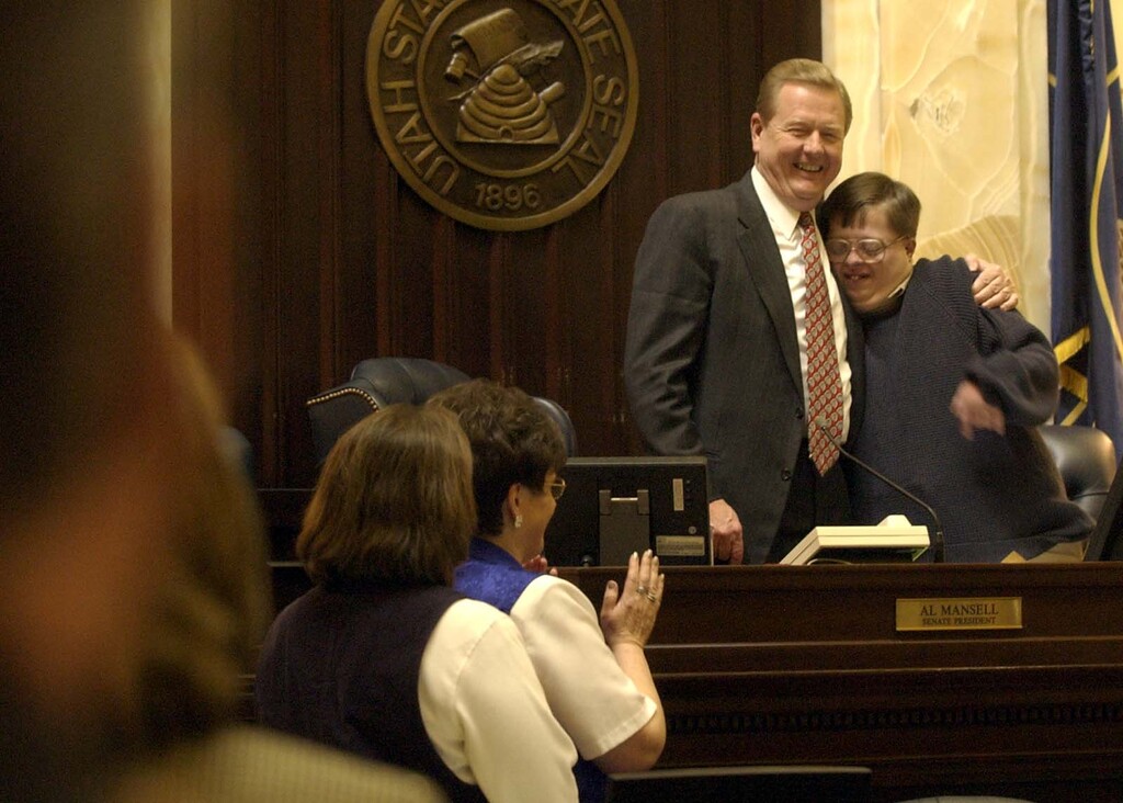 (Leah Hogsten  |  Tribune file photo) Matt Hillyard, son of longtime state lawmaker Lyle Hillyard, R-Logan, was a longtime fixture in the Utah state Senate, often accompanying his parents during long days on Capitol Hill. In this 2002 photo, Matt Hillyard gets a hug from then-Senate President Al Mansell after senators sang to him on his 27th birthday.