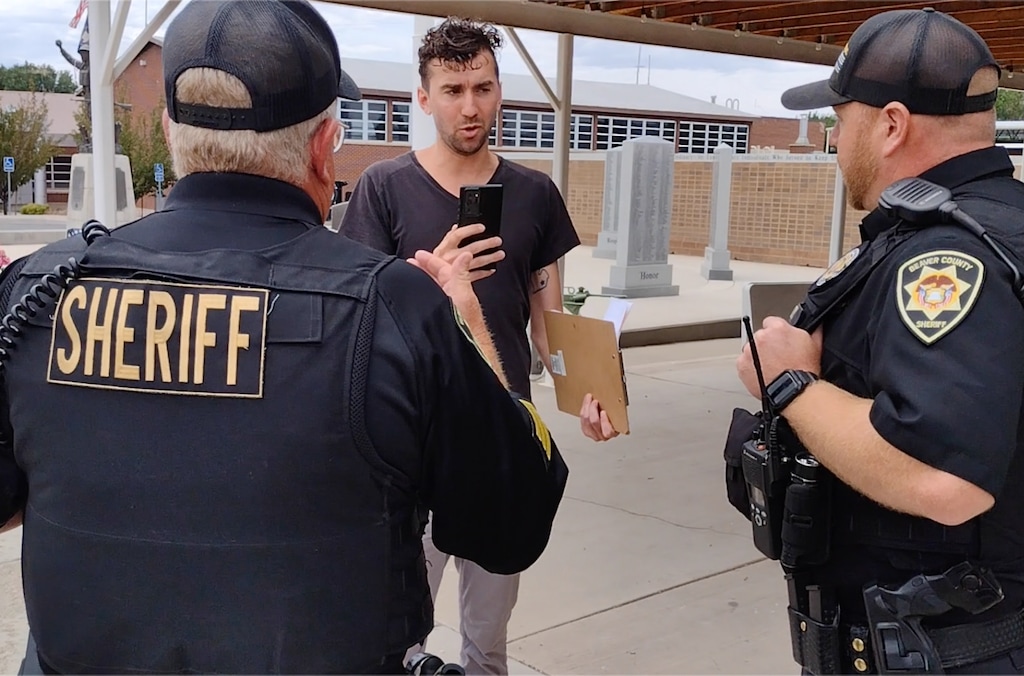 (Leo Chia) A screenshot from video recorded by Leo Chia shows Curtis Vollmar being confronted by Beaver County Sheriff’s Sgt. Warren Woolsey, left, and Deputy Lonnie Laws in Beaver, Saturday, July 23, 2022.