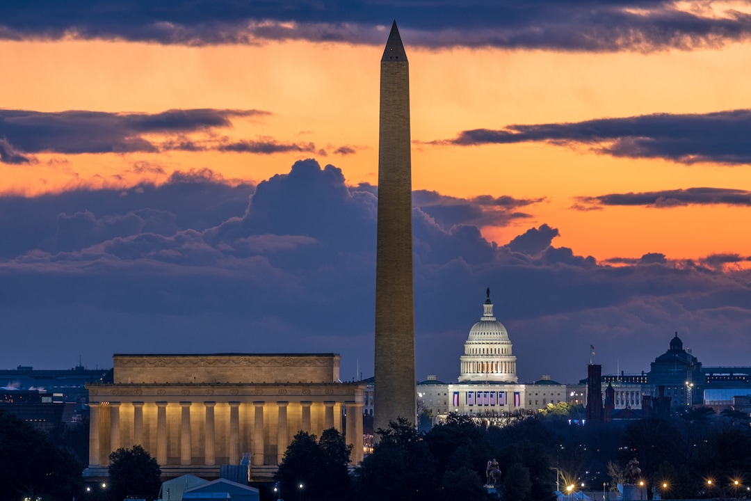 Dawn breaks behind the Lincoln Memorial, Washington Monument, and the U.S. Capitol on Inauguration Day in Washington, Wednesday, Jan. 20, 2021. President-elect Joe Biden will be sworn in as the 46th President of the United States of America at noon. (AP Photo/J. David Ake)