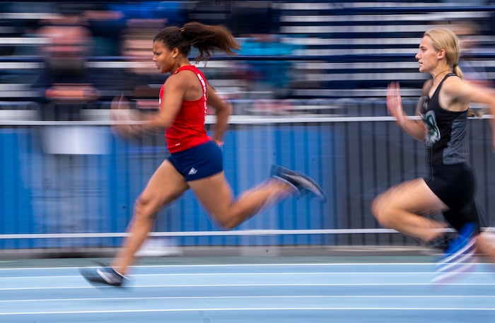 (Rick Egan | The Salt Lake Tribune)  Samoya Jones, Crimson,  leads Cambree Tensmeyer, GCYN, heat one of the 4A Girl's 100 Meter race, at the Utah High School State Track Meet, at BYU on Friday, May 20, 2022.
