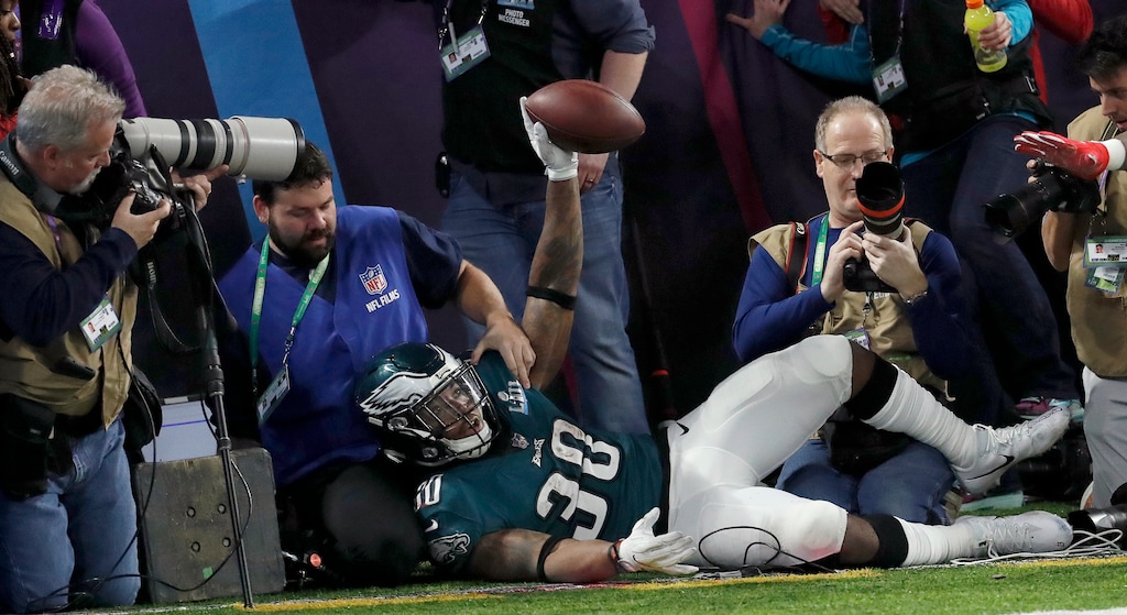 Philadelphia Eagles' Corey Clement crashes into photographers after catching a touchdown pass during the second half of the NFL Super Bowl 52 football game against the New England Patriots Sunday, Feb. 4, 2018, in Minneapolis. (AP Photo/Matt York)