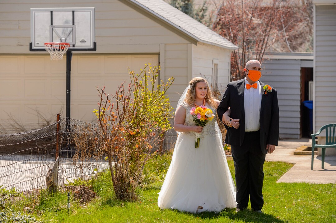 (Trent Nelson  |  The Salt Lake Tribune) Kadie Smeding prepares to walk the aisle and marry her fiance Tyler van Roosendaal in a Salt Lake City yard on Saturday, April 4, 2020.