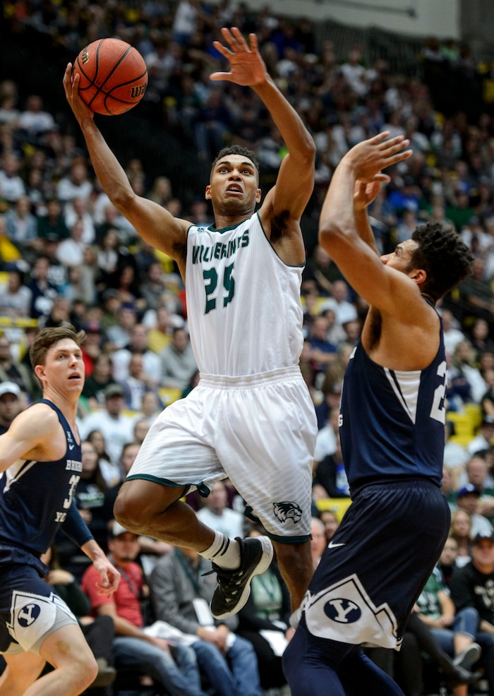 (Steve Griffin  |  The Salt Lake Tribune) Utah Valley Wolverines guard Kenneth Ogbe (25) gets past Brigham Young Cougars forward Yoeli Childs (23) for a basket during the BYU versus UVU basketball game at UCCU Center on the UVU campus in Orem Wednesday November 29, 2017.