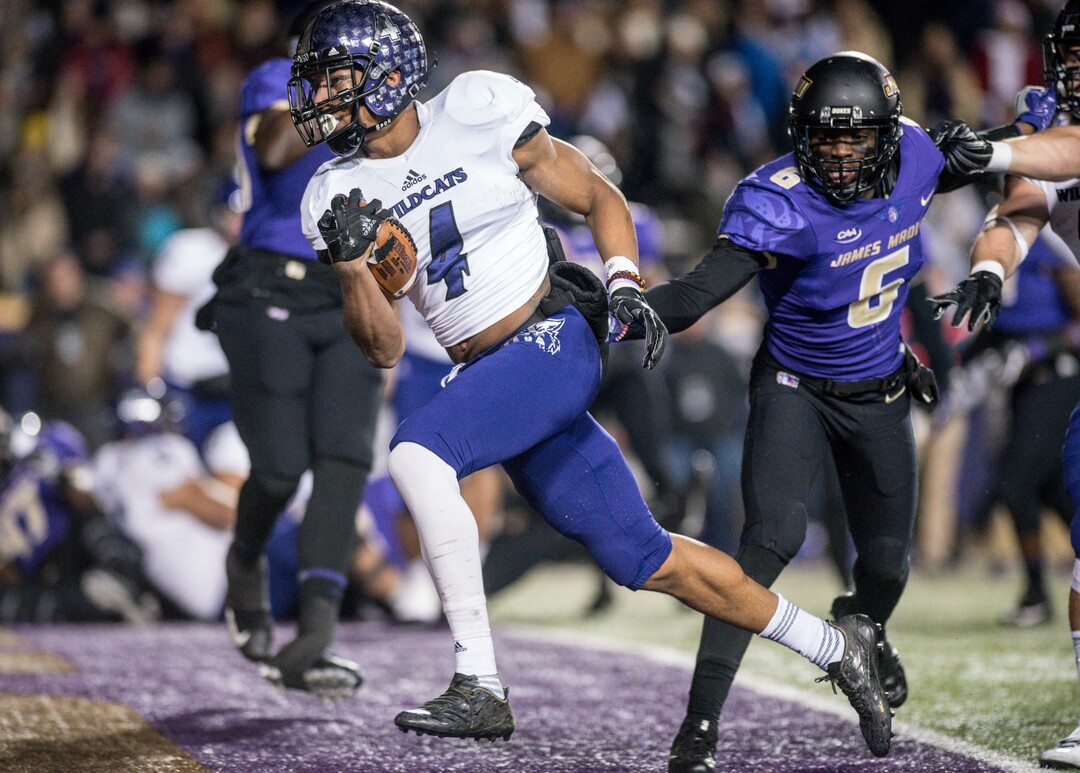 Weber State running back Kevin Smith (4) runs past James Madison cornerback Jimmy Moreland (6) to score a touchdown during the first half of an NCAA college football game in the quarterfinals of the FCS playoffs Friday, Dec. 8, 2017, in Harrisonburg, Va. (Daniel Lin/Daily News-Record via AP)