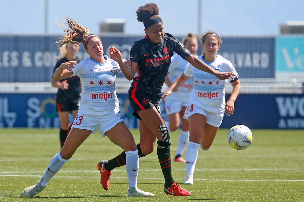 Chicago Red Stars defender Julia Bingham (23) defends against Portland Thorns FC forward Simone Charley, center, during the first half of an NWSL Challenge Cup soccer match at Zions Bank Stadium on Wednesday, July 1, 2020, in Herriman, Utah. (AP Photo/Rick Bowmer)