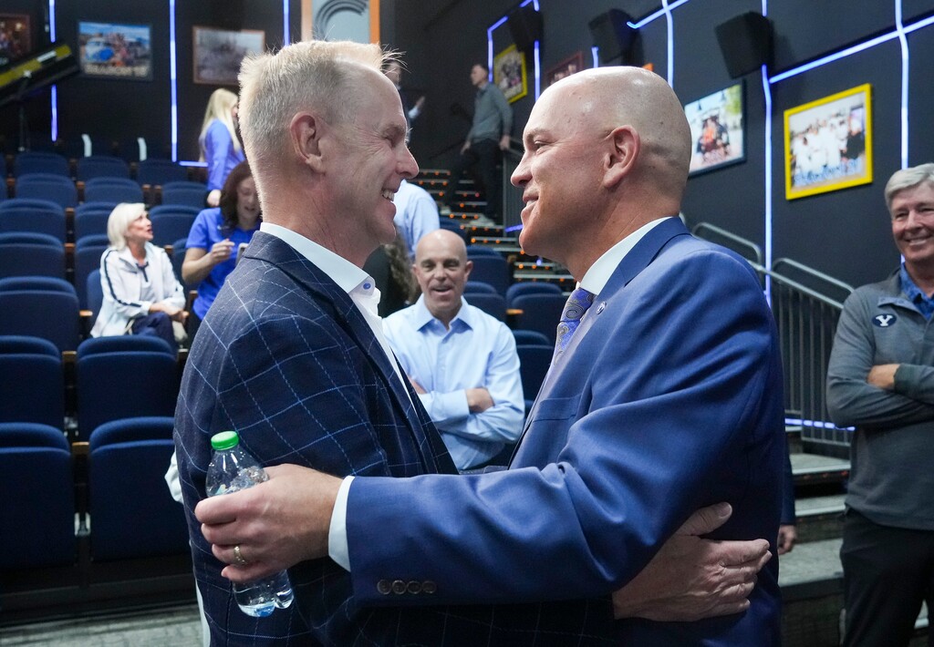 (Bethany Baker | The Salt Lake Tribune) Former BYU athletic director Tom Holmoe, left, embraces Brian Santiago after a press conference following the announcement of Santiago as the new BYU athletic director at Brigham Young University in Provo on Wednesday, May 14, 2025.