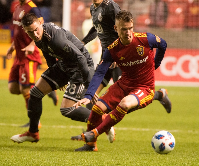 (Rick Egan  |  The Salt Lake Tribune)      Real Salt Lake midfielder Albert Rusnak (11) brings the ball upfield as Vancouver Whitecaps defender Jake Nerwinski (28) defends, in MLS action between Real Salt Lake and Vancouver Whitecaps, at Rio Tinto Stadium beSaturday, April 7, 2018.



