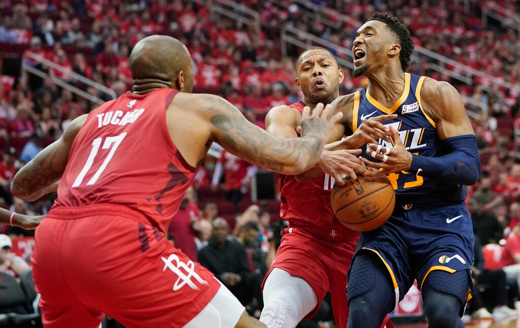 Houston Rockets defenders PJ Tucker (17) and Eric Gordon, center, block the path of Utah Jazz guard Donovan Mitchell, right, during the second half of Game 2 of a first-round NBA basketball playoff series in Houston, Wednesday, April 17, 2019. (AP Photo/David J. Phillip)