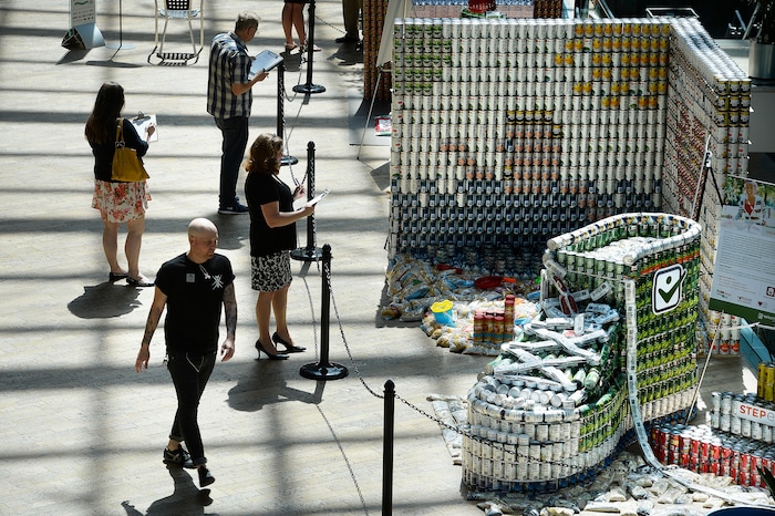 (Scott Sommerdorf | The Salt Lake Tribune) Visitors to the Salt Lake City Public Library walk past the stepexpress.com shoe made out of cans and sardines for he laces as the library hosted a community display and food drive focused on healthy food items for the Utah Food Bank. Teams from six local health careÐrelated businesses built giant sculptures using healthy canned, bagged, and boxed foods. The replica of Rice-Eccles Stadium won the public choice award, Thursday, August 10, 2017.