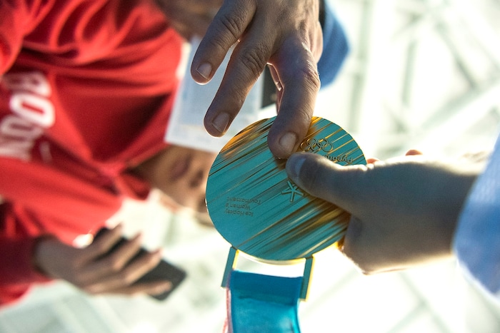 (Chris Detrick  |  The Salt Lake Tribune) United States forward Amanda Pelkey (37) lets a fan touch her gold medal after winning the Women's Gold Medal Game at Gangneung Hockey Centre during the Pyeongchang 2018 Winter Olympics Thursday, Feb. 22, 2018. United States defeated Canada 3-2 in a shootout victory. 