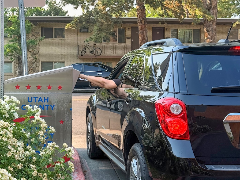 (Sydney Jezik | The Salt Lake Tribune) A voter drops off a ballot in Orem on Tuesday, June, 23, 2026.