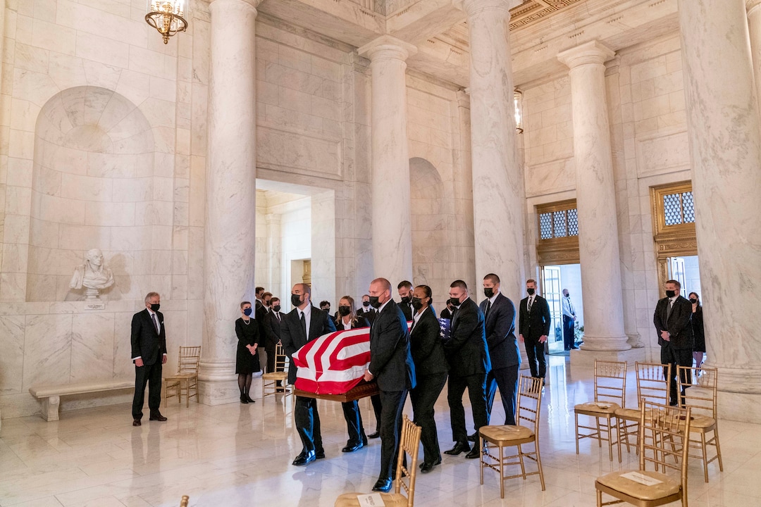 The flag-draped casket of Justice Ruth Bader Ginsburg, carried by Supreme Court police officers, arrives in the Great Hall at the Supreme Court in Washington, Wednesday, Sept. 23, 2020. Ginsburg, 87, died of cancer on Sept. 18. (AP Photo/Andrew Harnik, Pool)