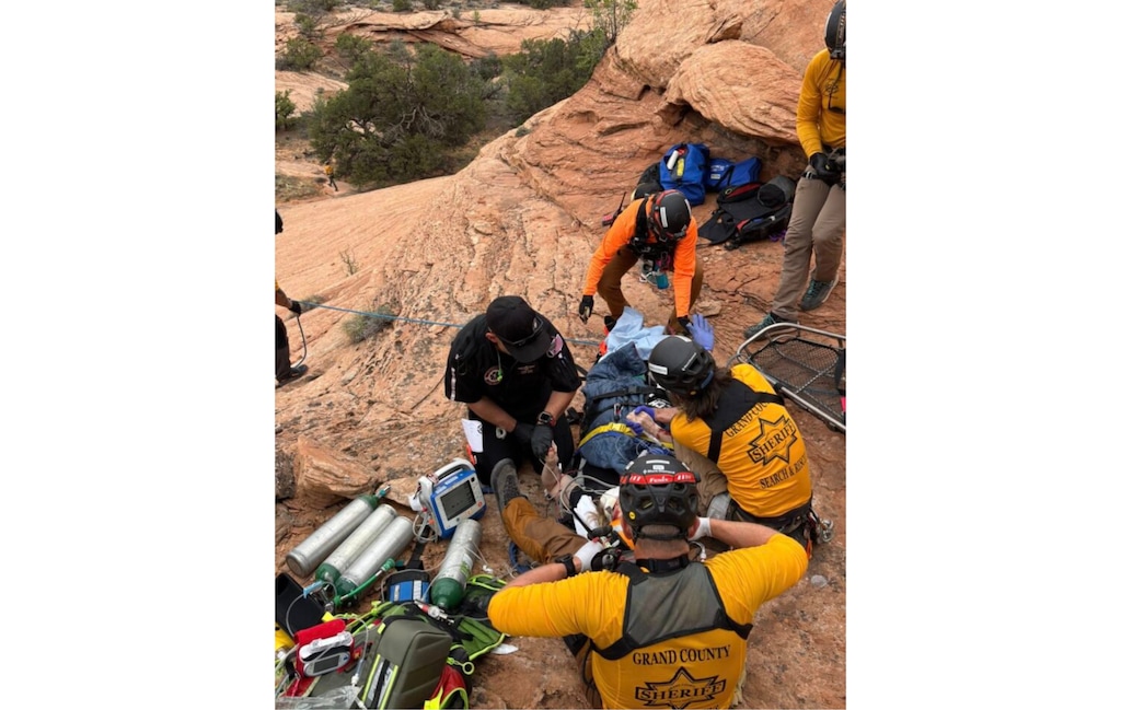 (Photo courtesy Grand County Search and Rescue) Grand County Search and Rescue personnel prepare equipment as a medical helicopter lands near Pritchett Canyon west of Moab during a rescue on April 10. A visitor was critically injured in a fall and airlifted to a trauma center.