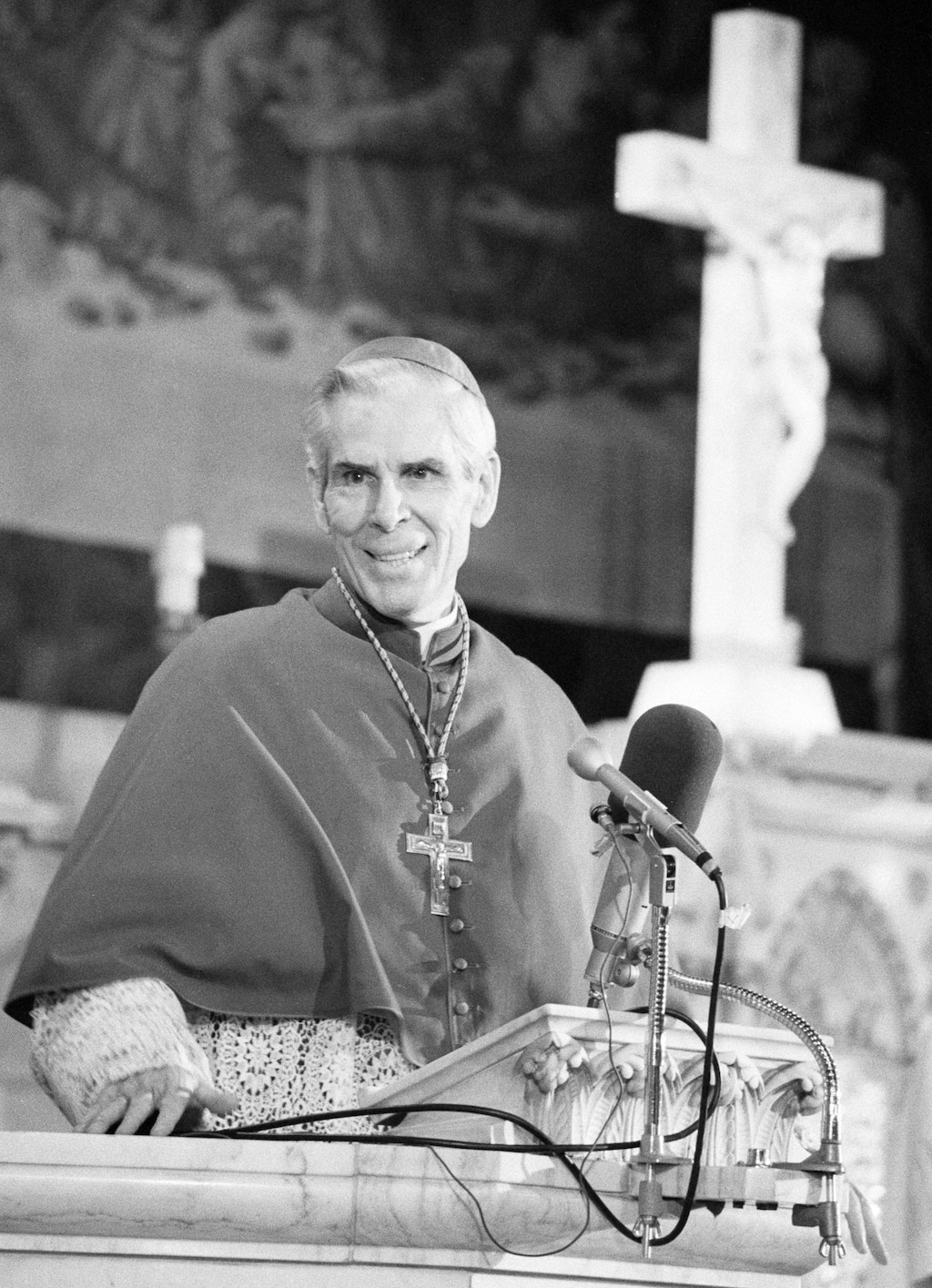 (AP Photo/Dave Pickoff, File) In this April 13, 1979m file photo, Bishop Fulton J. Sheen appears before parishioners on Good Friday at New York's St. Agnes Roman Catholic Church. Pope Francis has approved a miracle bringing the Sheen, the late American Archbishop known for his revolutionary radio and TV preaching, closer to sainthood. The Vatican announced the move Saturday, July 6, 2019 which clears the way for beatification. It comes just weeks after a New York court ruling allowing Sheen's niece to bury him in Peoria, Illinois, where he was ordained, ending years of litigation and allowing the process for sainthood to resume.