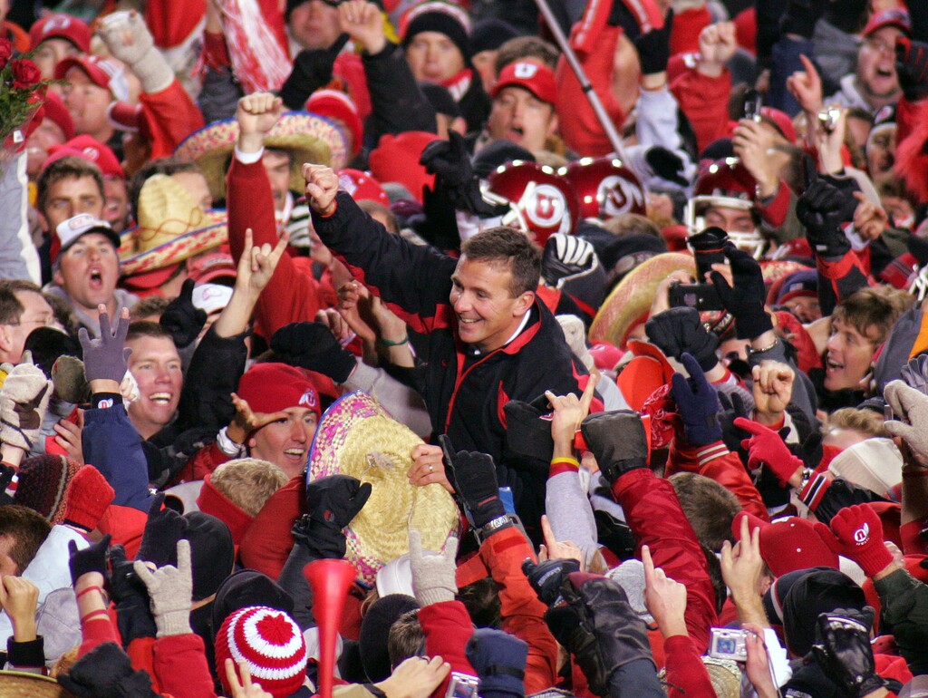 Utah coach Urban Meyer rides the shoulders of fans, celebrating victory. Utah vs. BYU college football.Photo by Trent Nelson; 11.20.2004