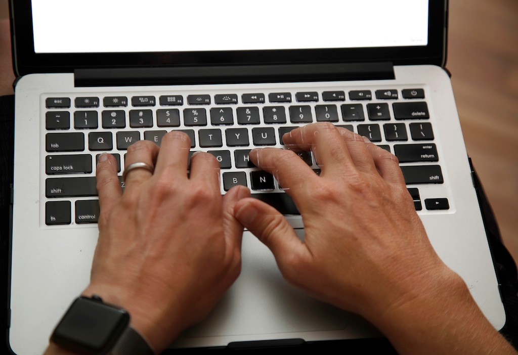 (Elise Amendola | AP file photo) In this June 19, 2017, photo, a person works on a laptop in North Andover, Mass. Telecommuting has become synonymous with convenience, flexible schedules and, yes, pajamas. You don’t have to commute, spend money on transportation or dress up. But despite the appeal and laid-back reputation, there are challenges.