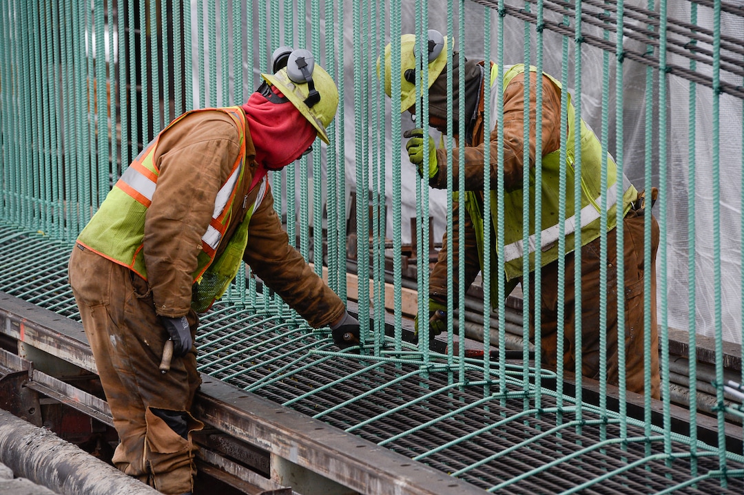 (Francisco Kjolseth  |  The Salt Lake Tribune)  Crew members Meli Kaufausi, left, and Simone Katoa work on the extensive structural integrity of a bridge beam at Forterra Structural Precast in Kearns on Tuesday, Dec. 11, 2018. UDOT is in the process of placing some of the world's largest-ever bridge beams, with the same design,  along the technology corridor in Lehi later this week.