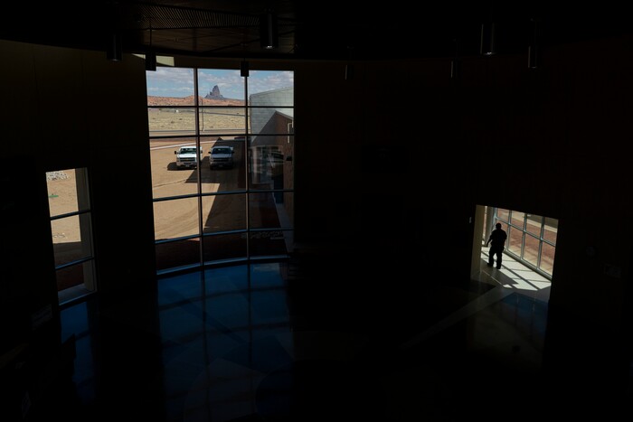 Agathla Peak is seen through the window of the Kayenta Health Center on the Navajo reservation in Kayenta, Ariz., on April 18, 2020. The reservation has some of the highest rates of coronavirus in the country. Team Rubicon is helping with medical operations as cases of COVID-19 surge. (AP Photo/Carolyn Kaster)
