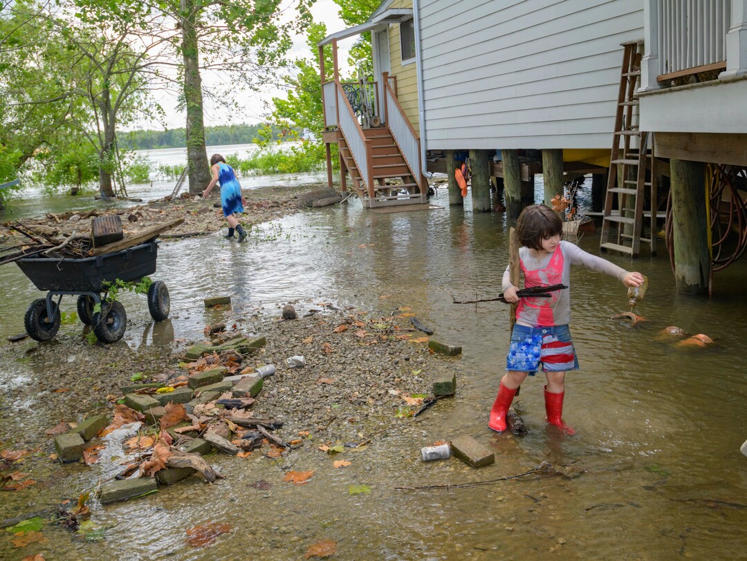 (Matthew Hinton | AP Photo) Delilah Campbell, 4, right, and her sister, Tallulah Campbell, 8, clear driftwood and other debris in preparation of Tropical Storm Barry near New Orleans, La., Thursday, July 11, 2019. The area is normally a driveway at her family's home that is one of the few on land called batture on the outside of the Mississippi River levee at the border of Orleans and Jefferson Parishes.