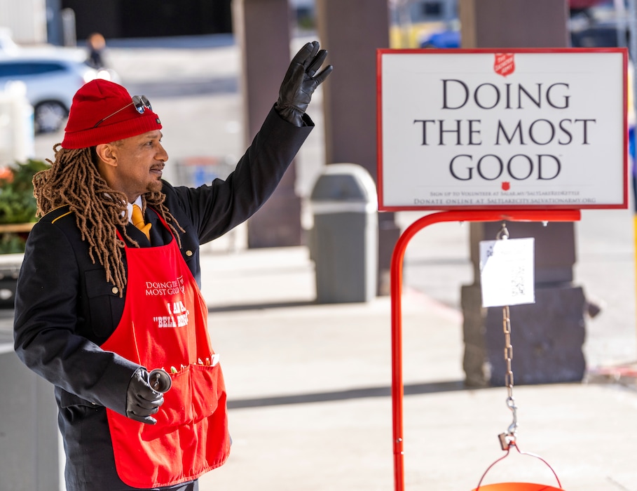 (Rick Egan | The Salt Lake Tribune) Salvation Army bell ringer Van Dodd waves at customers at a shopping center on Parleys Way on Tuesday, Dec. 14, 2021.