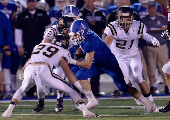 (Leah Hogsten | The Salt Lake Tribune) Bingham's Kaden Clemens gets another first down for the Miners. Bingham High School leads Lone Peak High School, 14-3 during their game Friday, September 28, 2017 in South Jordan.