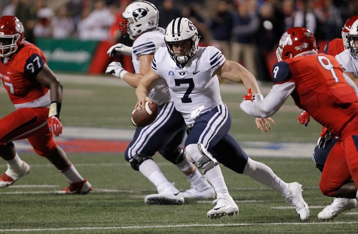 BYU quarterback Beau Hoge tries to avoid Fresno State's Jeffrey Allison, right, during the first half of an NCAA college football game in Fresno, Calif., Saturday, Nov. 4, 2017. (AP Photo/Gary Kazanjian)