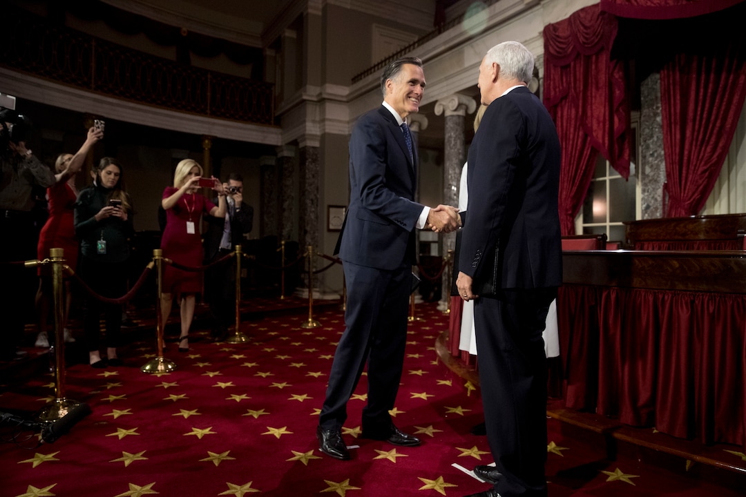 Vice President Mike Pence greets Sen. Mitt Romney, R-Utah, as he arrives for a mock swearing in ceremony in the Old Senate Chamber on Capitol Hill in Washington, Thursday, Jan. 3, 2019, as the 116th Congress begins. (AP Photo/Andrew Harnik)