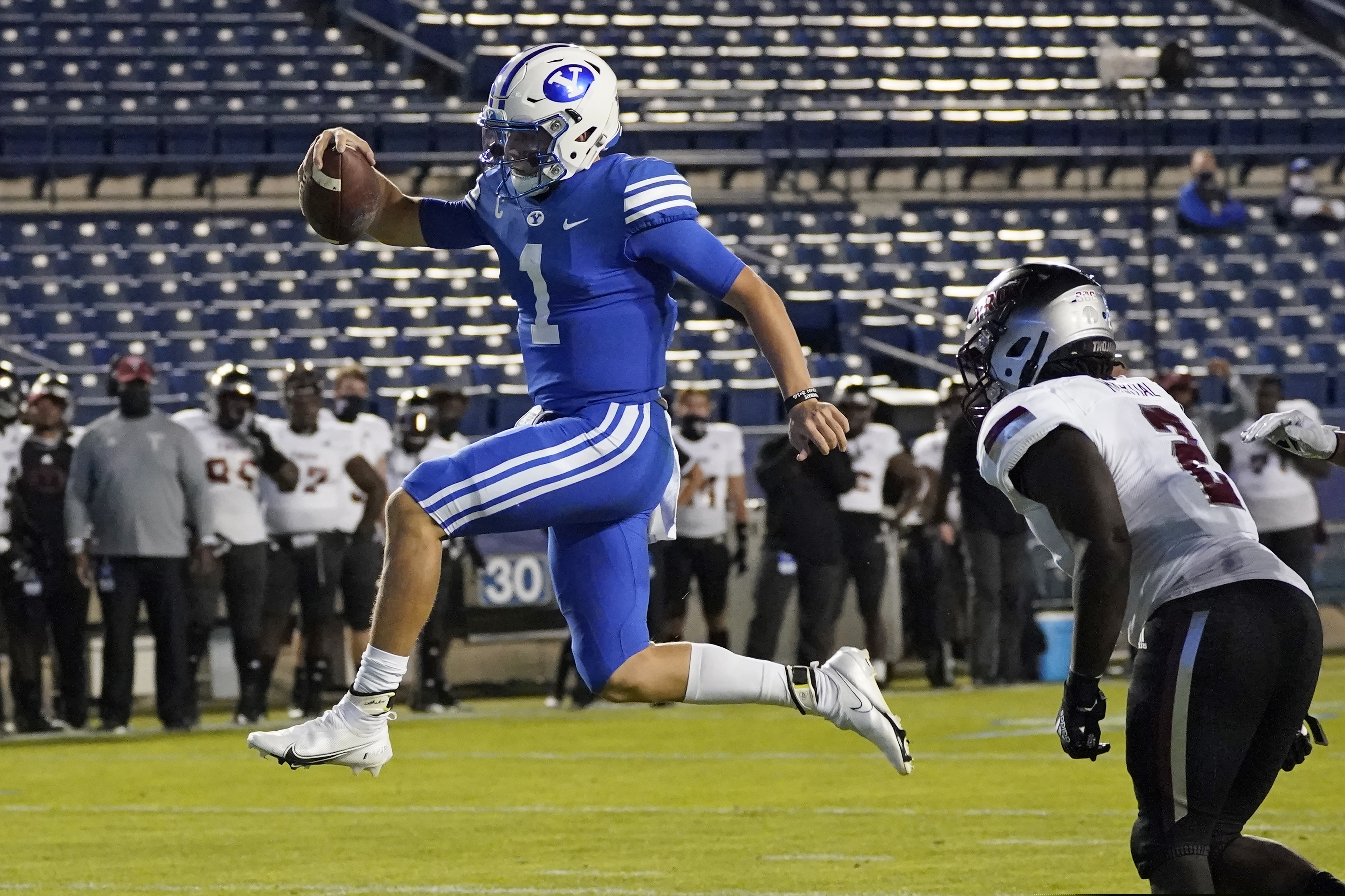 BYU quarterback Zach Wilson (1) leaps into the end zone, next to Troy linebacker Carlton Martial (2) during the second half of an NCAA college football game Saturday, Sept. 26, 2020, in Provo, Utah. (AP Photo/Rick Bowmer, Pool)