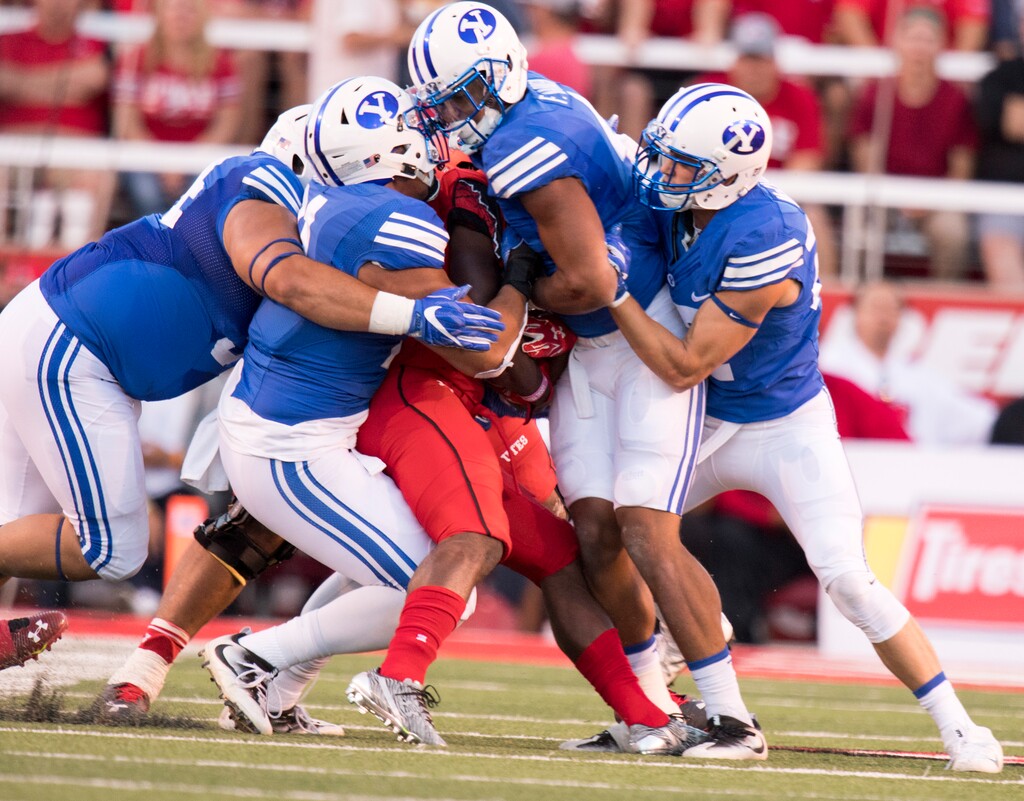 (Rick Egan | Tribune file photo) The Brigham Young Cougars defense stops Utah Utes running back Zack Moss (2) as BYU plays Utah at Rice-Eccles Stadium, Saturday, September 10, 2016.