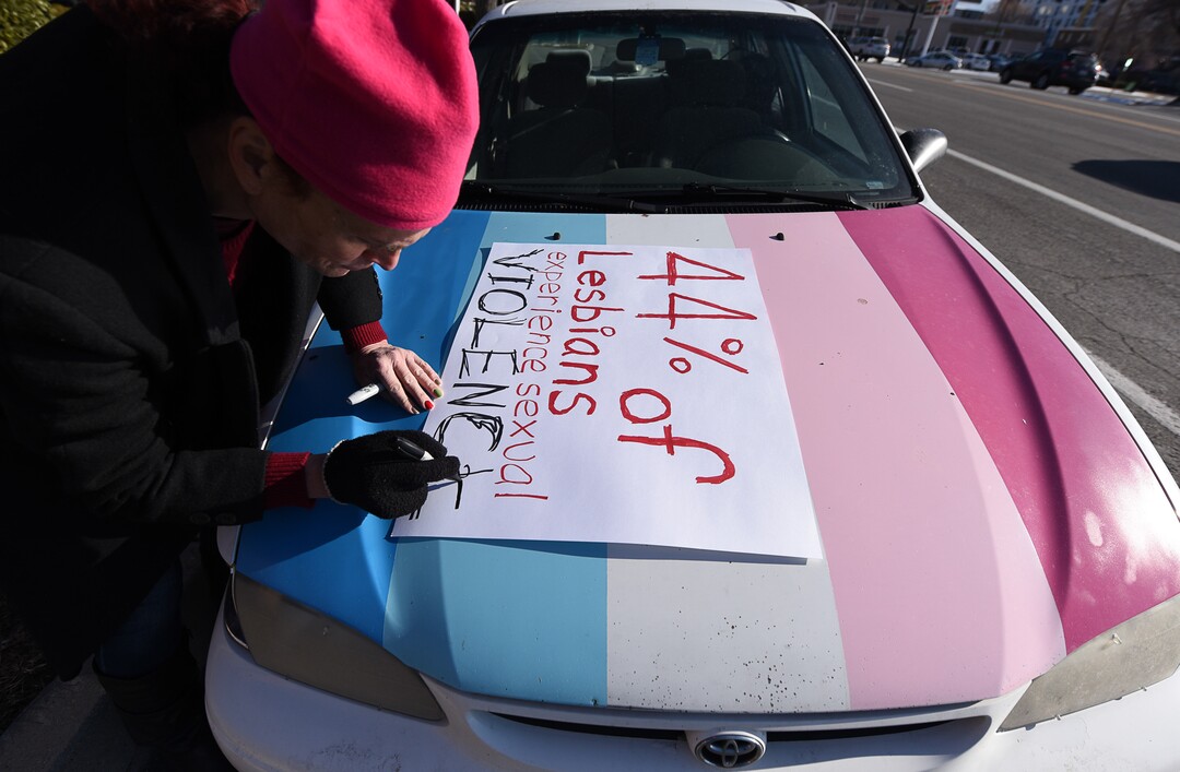 (Francisco Kjolseth  |  The Salt Lake Tribune)  Rachel Edward joins other activists in Utah to protest Salt City Tattoo on Friday, Dec. 22, 2017, following an Instagram post made by the shop's official Instagram account. The post in question was of a gift provided during the shop's white elephant exchange, a gift one of the artists at the parlor called a "rape kit," containing leather gloves, black duct tape, a bottle of lubricant, rope, and a knife.
